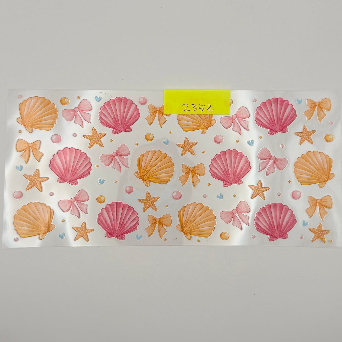 yellow, pink shells and bows
