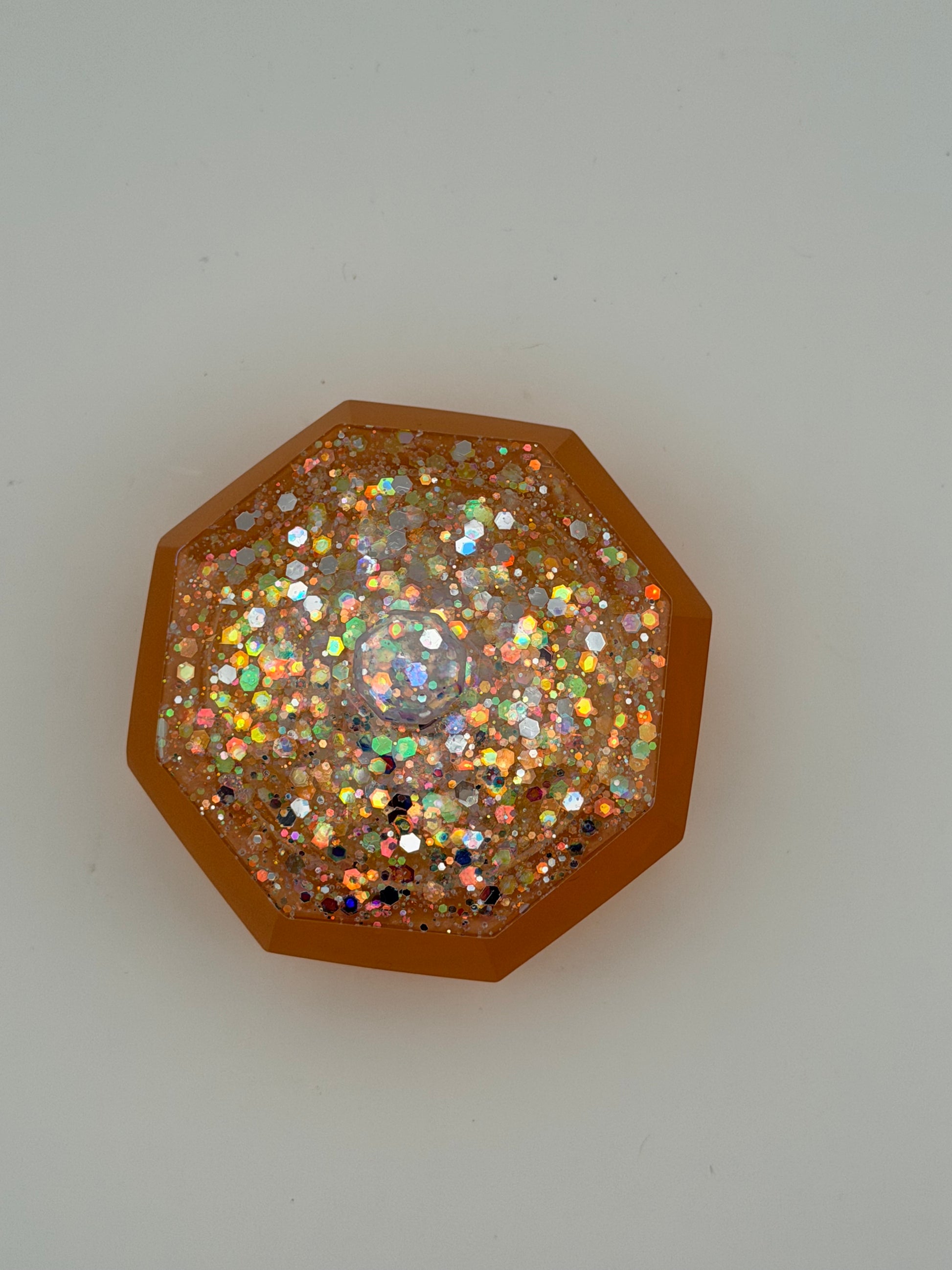 Small Irridescent glitter with orange base container with lid