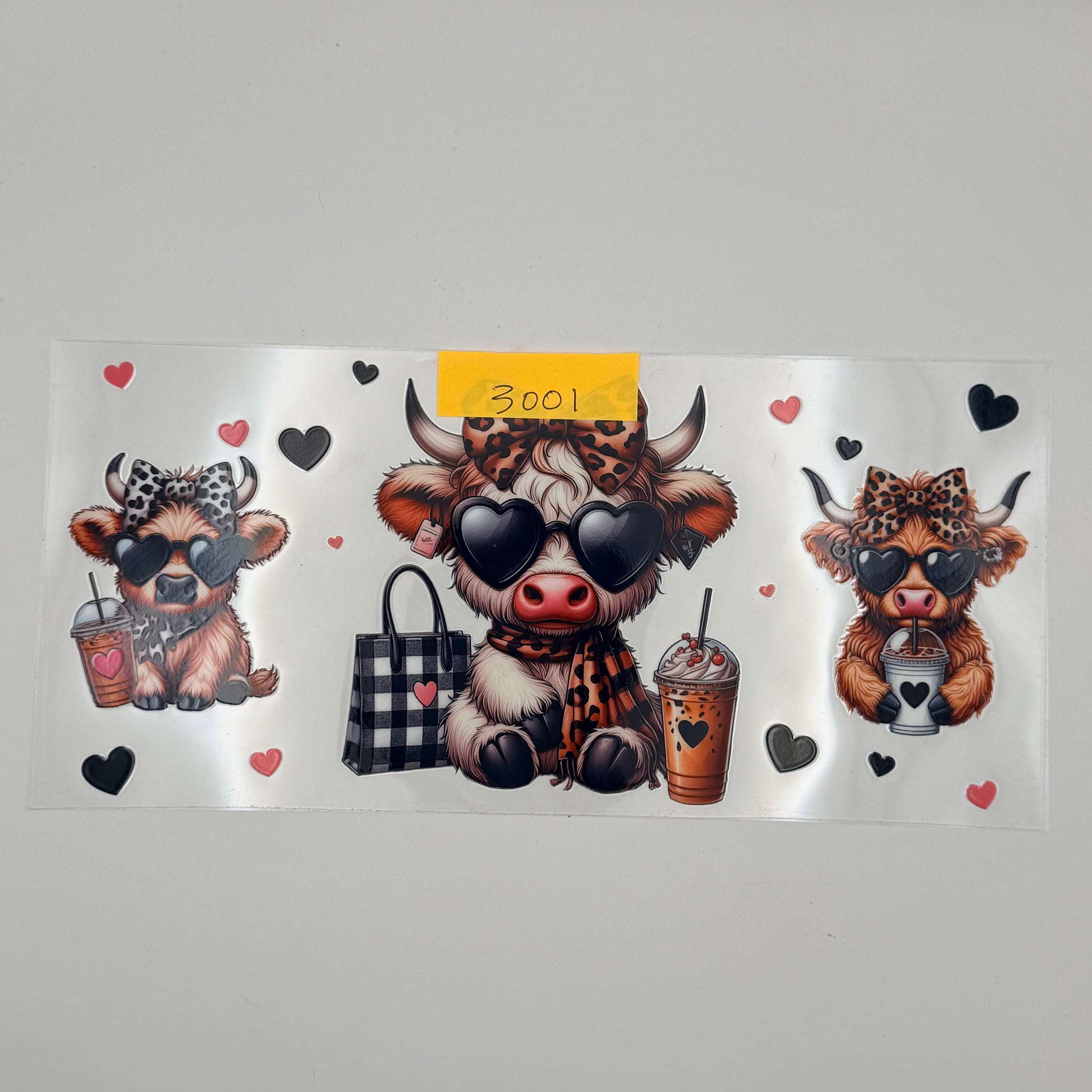 highland cow with leopard print bows with coffee
