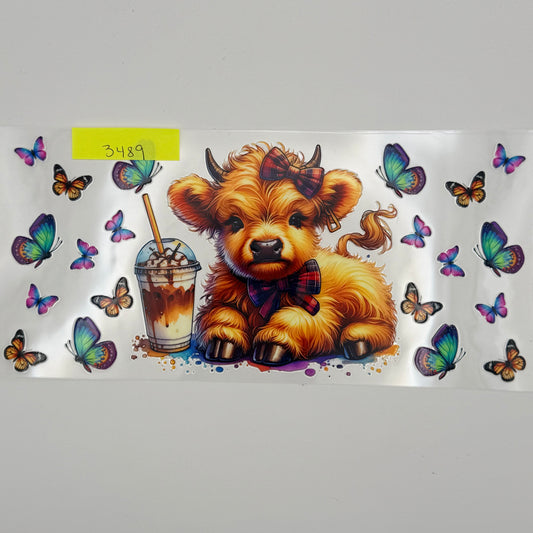 Highland cow with coffee and butterflies